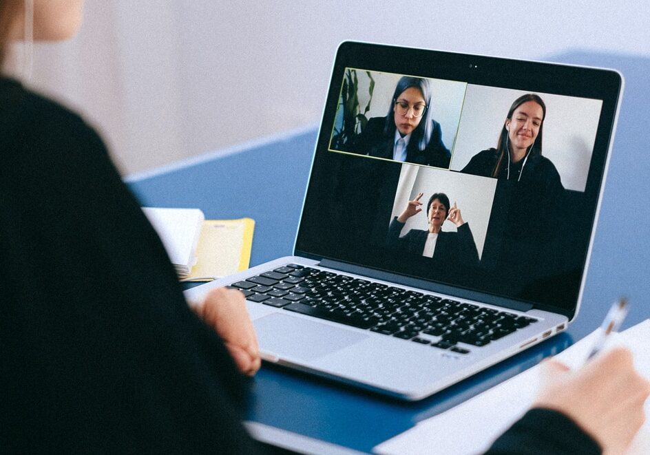 A laptop Zoom call among four people.