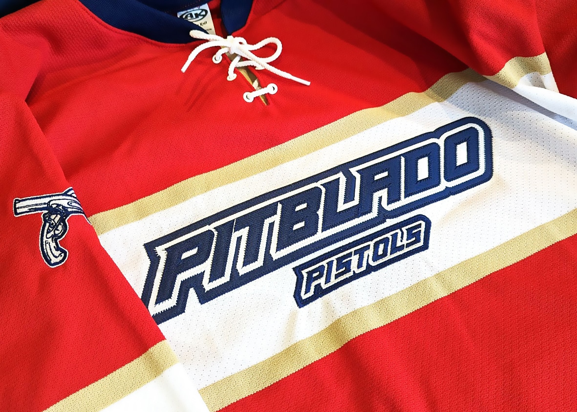 A red hockey jersey that reads "Pitblado Pistols"
