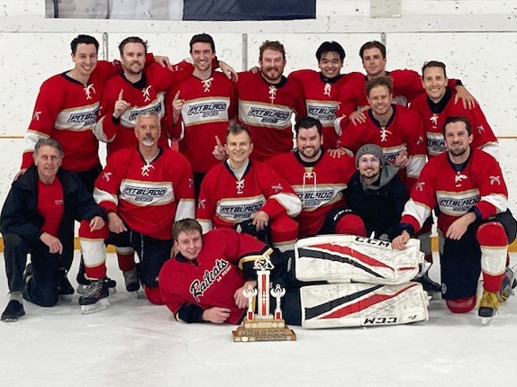 Group photo of the Pitblado Pistols hockey team.