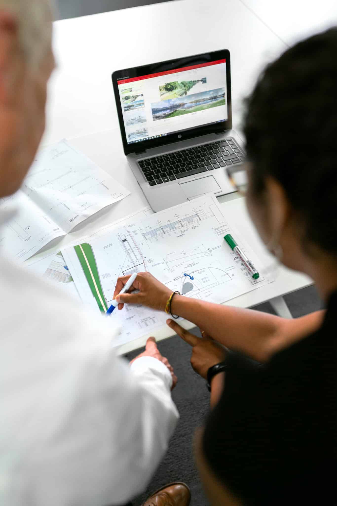 Two people reviewing business plans.